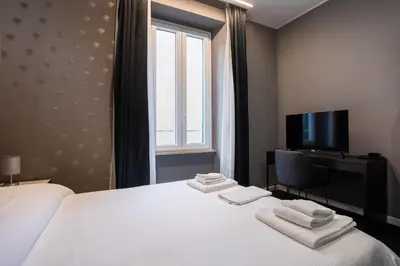 a hotel room with a bed and a window at SABA SUITE ROMA in Rome