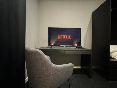 a desk with a monitor and a chair in a room at SABA SUITE ROMA in Rome