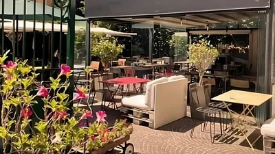 a restaurant with tables and chairs and flowers at SABA SUITE ROMA in Rome