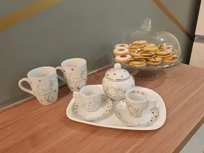a table with a tray of donuts and tea cups at Domus Aldini in Rome