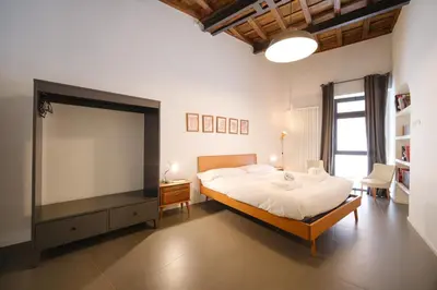 a bedroom with a large bed and a television at Golden House BuddyRent in Rome