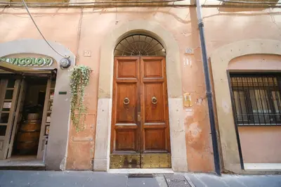 a wooden door on the side of a building at Golden House BuddyRent in Rome