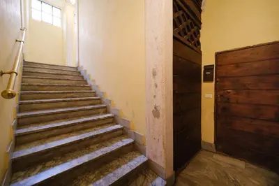 a staircase in an old building with a door at Golden House BuddyRent in Rome