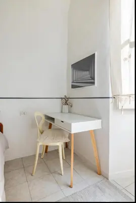 a white desk with a chair in a room at Romeo. Luminoso appartamento al centro di Roma in Rome