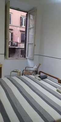 a bedroom with two beds and a window at Romeo. Luminoso appartamento al centro di Roma in Rome