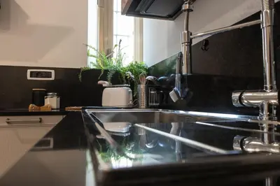 a kitchen with a sink and a counter top at Casa Matteo53, Termini in Rome