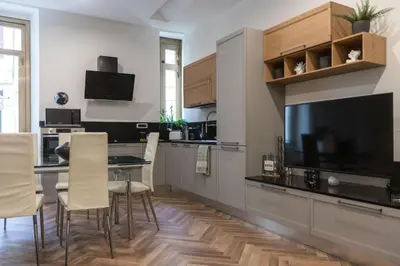 a kitchen with a table and chairs and a television at Casa Matteo53, Termini in Rome