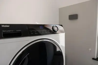 a white washing machine sitting in a room at Casa Matteo53, Termini in Rome