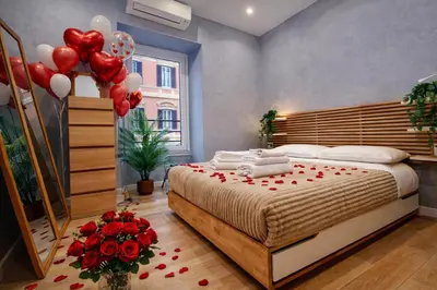 a bedroom with a bed with red roses and balloons at Simona's Vatican in Rome