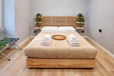 a bedroom with a large bed with towels on it at Simona's Vatican in Rome