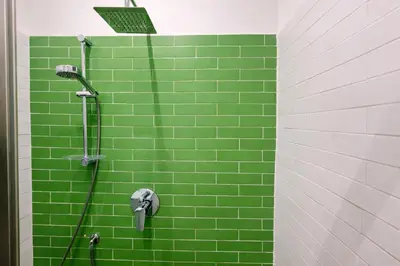 a green tiled shower with a green tile wall at Simona's Vatican in Rome