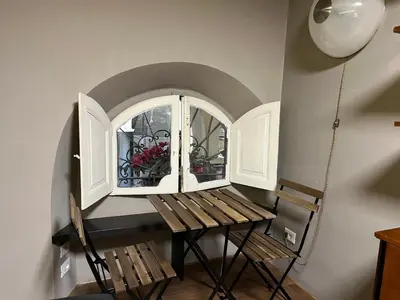 a room with a table and a bench and a window at Appartamento Minimal Roma centro in Rome