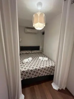 a bedroom with a bed and a chandelier at Appartamento Minimal Roma centro in Rome