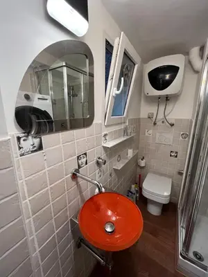 a bathroom with a red sink and a toilet at Appartamento Minimal Roma centro in Rome