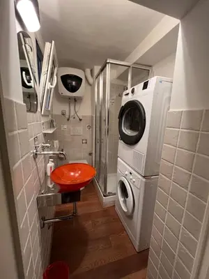 a bathroom with a washing machine and a washer at Appartamento Minimal Roma centro in Rome