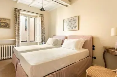 a bedroom with a large white bed and a window at Trastevere Luxury Home in Rome