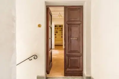 a hallway with a wooden door in a room at Trastevere Luxury Home in Rome