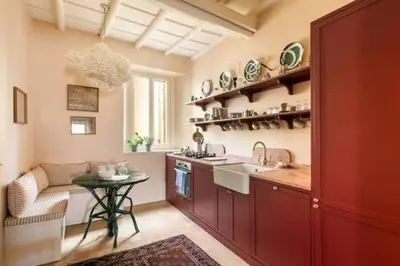 a large kitchen with a sink and a table at Trastevere Luxury Home in Rome
