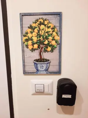 a picture of a tree with oranges on a door at RomAntica Lemon Apartment in San Giovanni in Rome