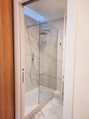 a shower with a glass door in a bathroom at RomAntica Lemon Apartment in San Giovanni in Rome