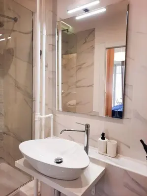 a white bathroom with a sink and a mirror at RomAntica Lemon Apartment in San Giovanni in Rome