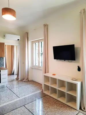 a living room with a flat screen tv on a wall at RomAntica Lemon Apartment in San Giovanni in Rome