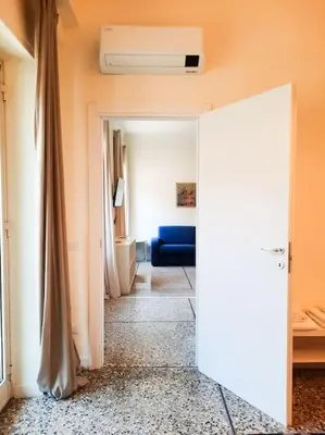 a room with a hallway with a door to a bathroom at RomAntica Lemon Apartment in San Giovanni in Rome