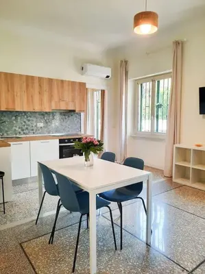 a kitchen with a white table and chairs in a room at RomAntica Lemon Apartment in San Giovanni in Rome