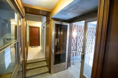 a hallway with glass doors leading to a building at ROMECOMING Ostiense Guest House in Rome