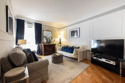 a living room with a couch and a television at Germanico Charming Maison in Rome
