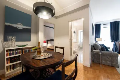 a living room with a dining table and a living room at Germanico Charming Maison in Rome