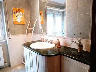 a bathroom with a sink and a mirror at Appartamento per le tue vacanze a Roma Villa Pamphili in Rome