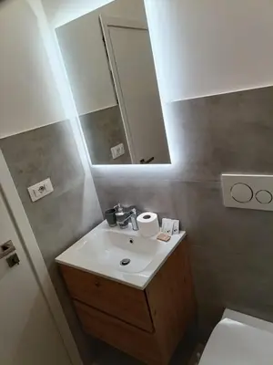 a bathroom with a sink and a mirror at Pop Corn Vatican Suites in Rome