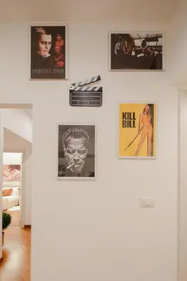 a wall of pictures on a wall in a living room at Pop Corn Vatican Suites in Rome