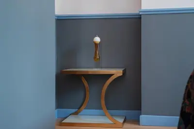 a small table in a room with a blue wall at Vatican Night Suites in Rome