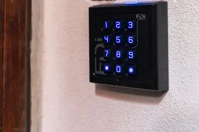 a black remote control on a wall with blue lights at Vatican Night Suites in Rome