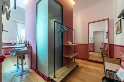 a room with a glass partition and a mirror at Vatican Night Suites in Rome