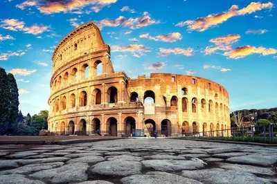 a large building with a cloudy sky behind it at K-Celimontana Apartment in Rome