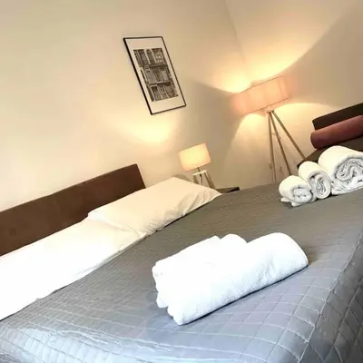 a bedroom with a bed with white towels on it at K-Celimontana Apartment in Rome