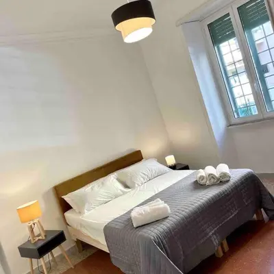 a bedroom with a bed with two towels on it at K-Celimontana Apartment in Rome