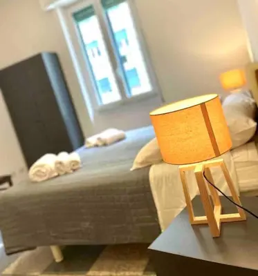 a bedroom with a bed and a table with a lamp at K-Celimontana Apartment in Rome
