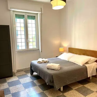 a bedroom with a bed with two towels on it at K-Celimontana Apartment in Rome
