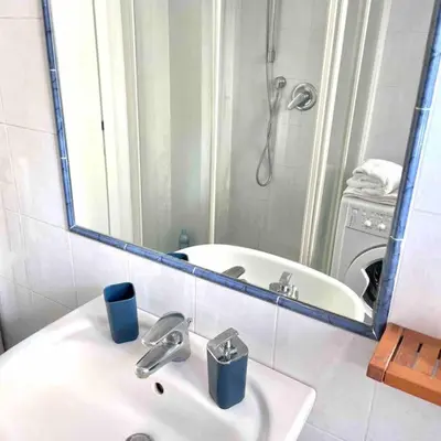 a bathroom with a sink and a tub and a mirror at K-Celimontana Apartment in Rome