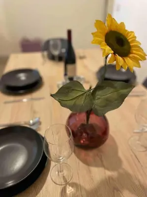a vase with a sunflower in it on a table at K-Celimontana Apartment in Rome