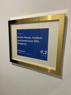 a framed picture on a wall with a gold frame at Savoia House, modern apartment near Villa Borghese in Rome