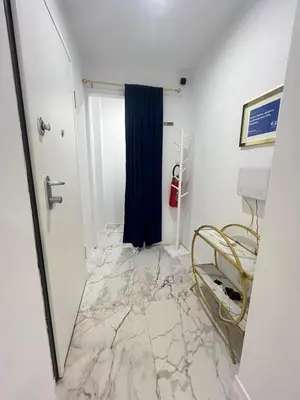 a room with a marble floor with a blue curtain at Savoia House, modern apartment near Villa Borghese in Rome