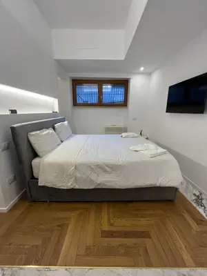a bedroom with a large bed and a window at Savoia House, modern apartment near Villa Borghese in Rome