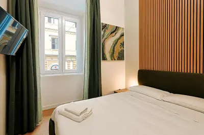 a bedroom with a bed and a window at Ottaviano Design Apartment at the Vatican in Rome