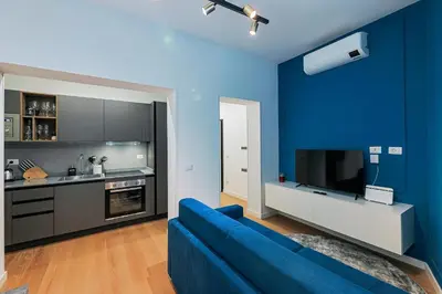 a blue living room with a blue wall at Ottaviano Design Apartment at the Vatican in Rome