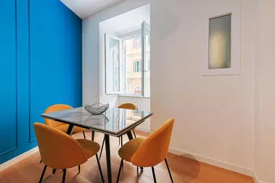a dining room with a glass table and chairs at Ottaviano Design Apartment at the Vatican in Rome